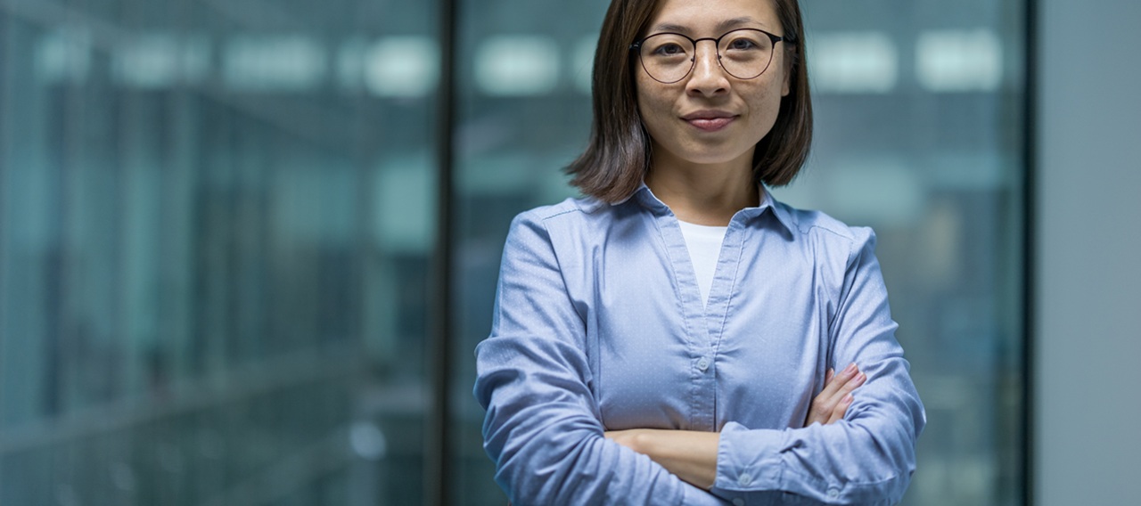 Portrait of confident serious woman inside office, Asian businesswoman looking focused at camera. Office worker working in evening